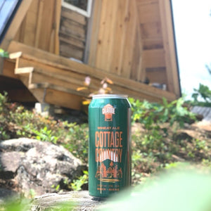 Can of Cottage Country Wheat Ale in front of an A-Frame