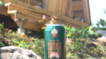 Can of Cottage Country Wheat Ale in front of an A-Frame